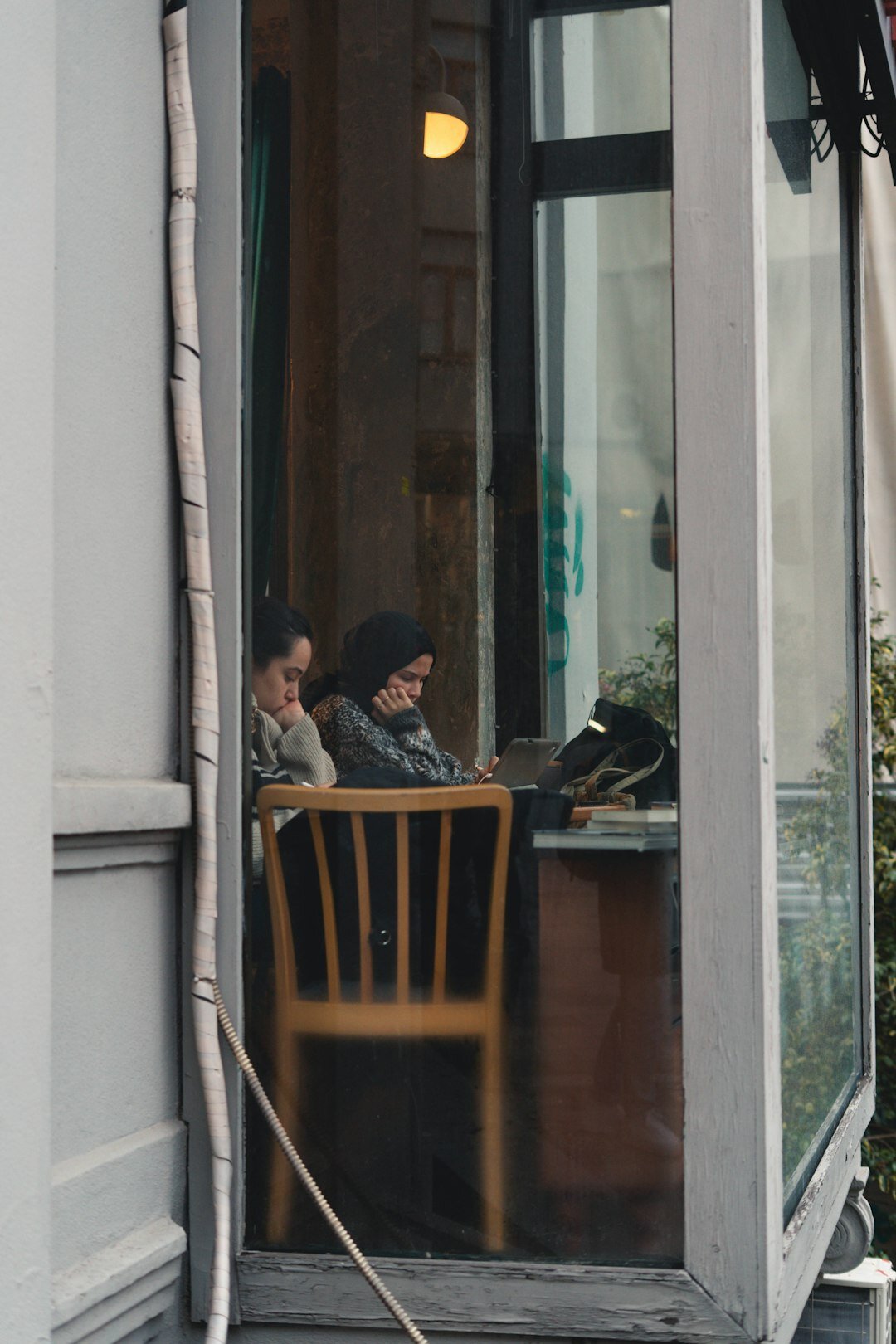 person reading book in cafe