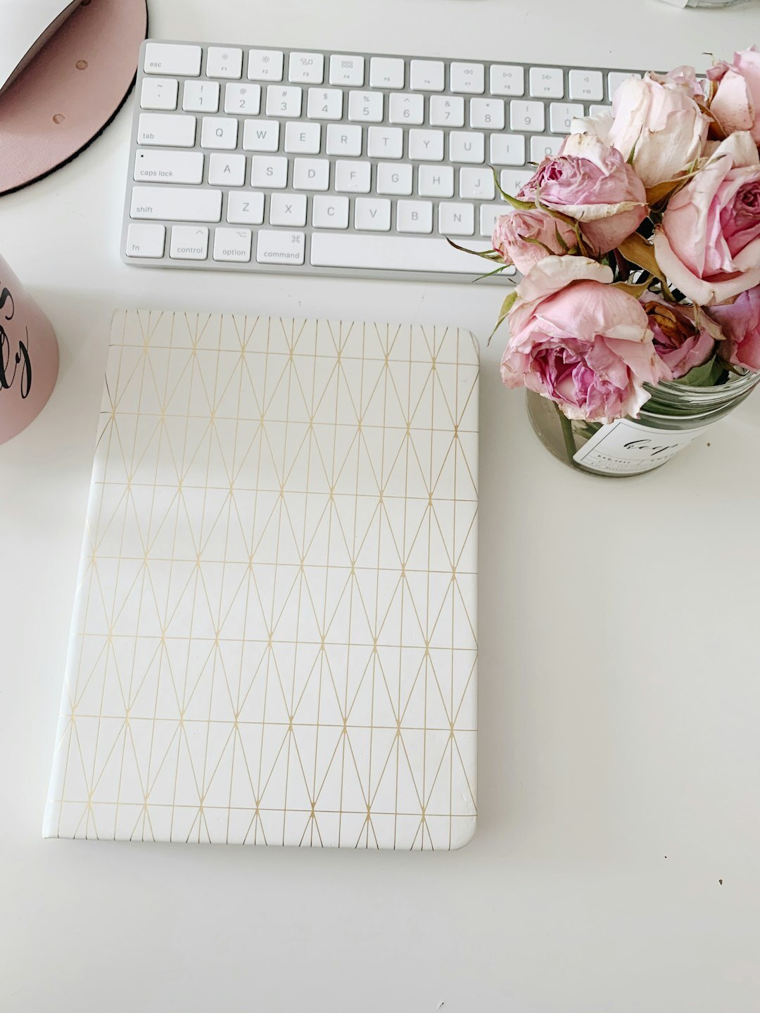 Flat lay of a planner, laptop and coffee cup on a desk